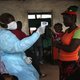 A Liberian Ministry of Health worker checks people for Ebola symptoms at a checkpoint near the international airport on Aug. 24, 2014, near Dolo Town, Liberia.
John Moore/Getty Images